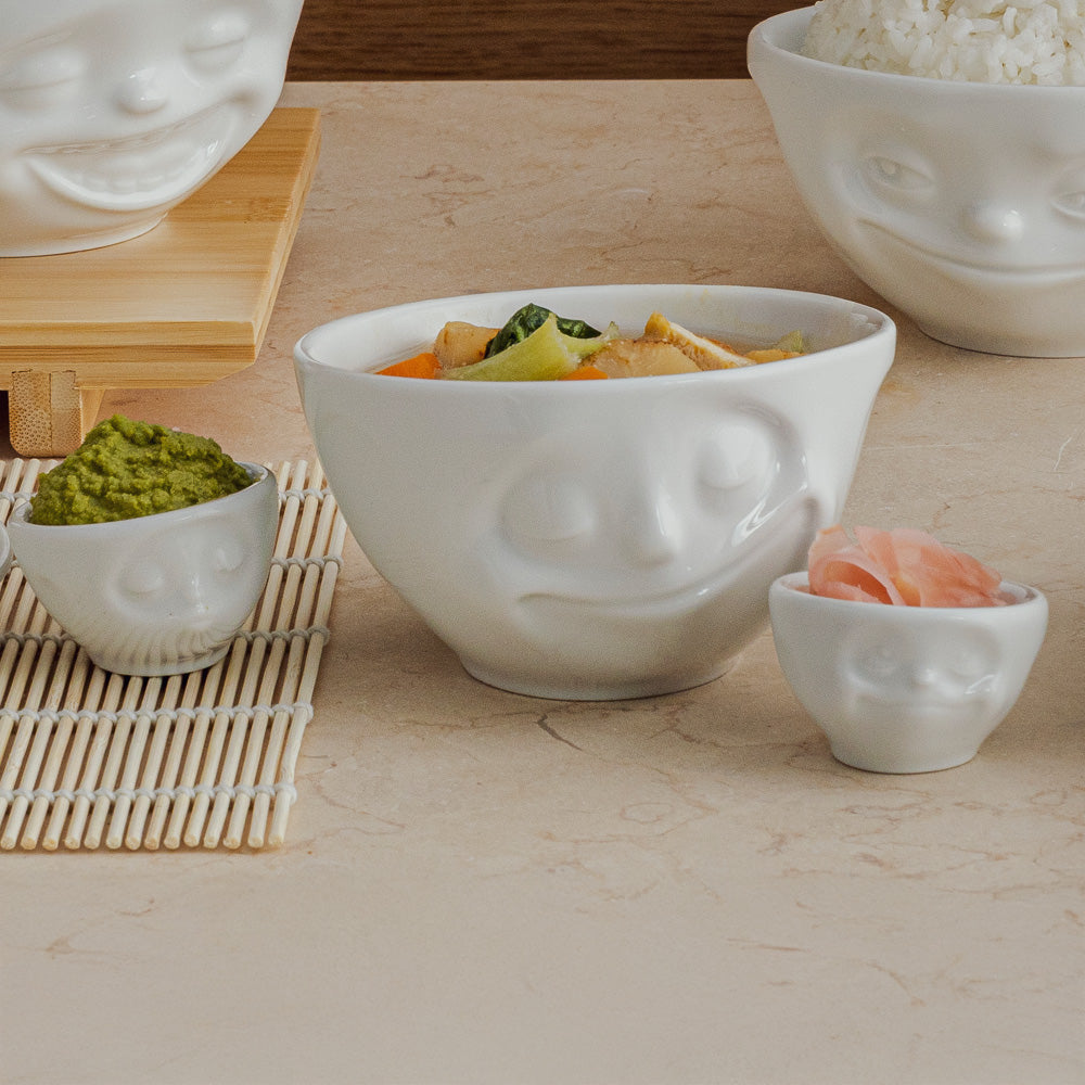 Set of two egg cups in white from the porcelain product family of fun dishware by FIFTYEIGHT Products. Set features two egg cups in white, featuring 'kissing' and 'dreamy' facial expressions. Dishwasher and microwave safe bowls. Shipped in exclusively designed gift box.