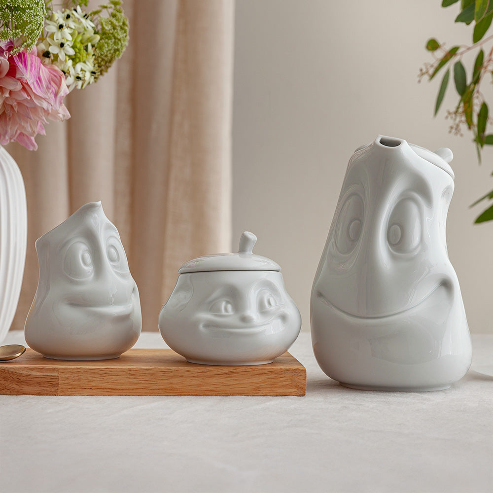 Premium porcelain creamer jug in white features a 'jolly' facial expression at 11 oz capacity. Serves milk, creamer, dressing, salsa, gazpacho, gravy, sauces and more. Detailed facial expression jug from the porcelain product family of fun dishware by FIFTYEIGHT Products. Shipped in exclusively designed gift box.