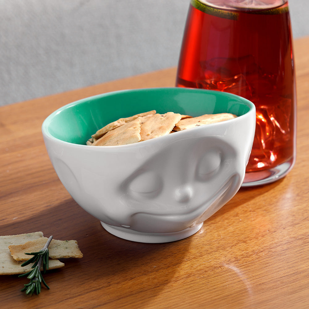 Premium porcelain bowl in white with jade color on the inside from the porcelain product family of fun dishware by FIFTYEIGHT Products. Offers 16 oz capacity perfect for serving cereal, soup, snacks and much more. Dishwasher and microwave safe bowl featuring a sculpted ‘happy’ facial expression. Shipped in exclusively designed gift box.