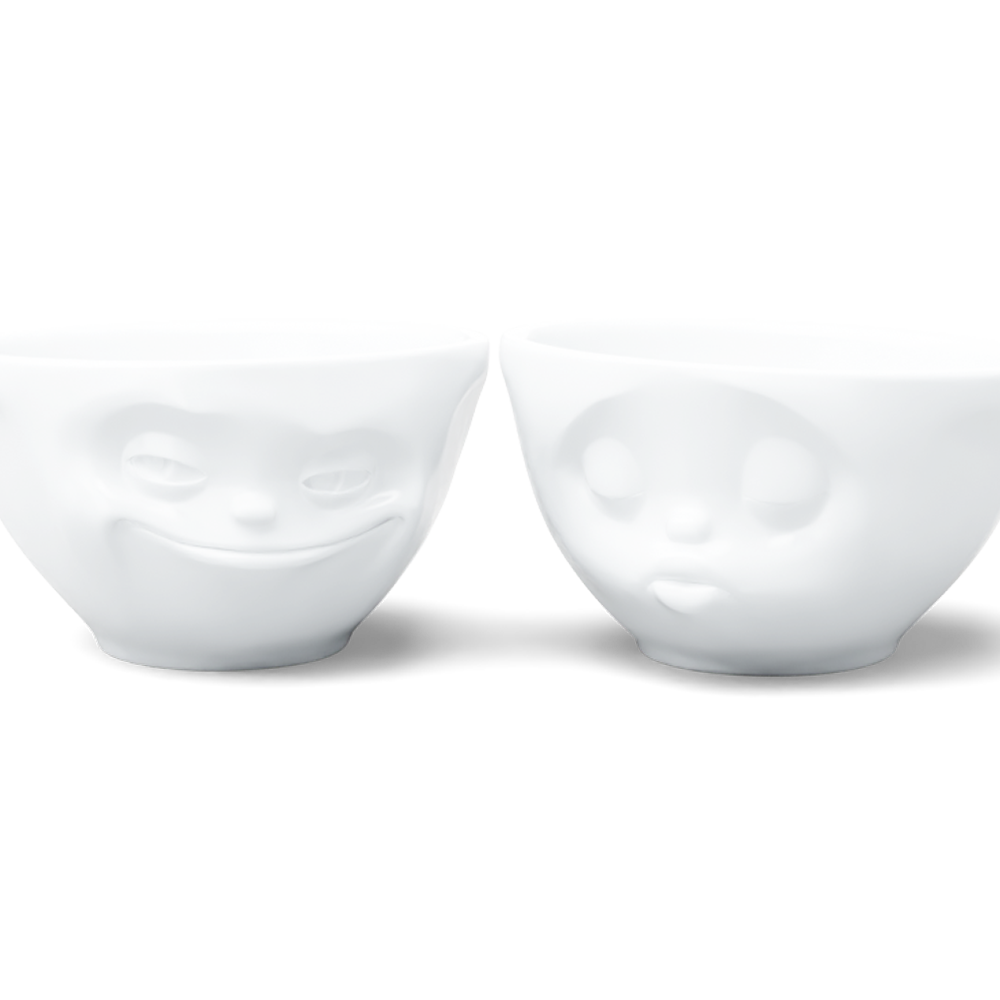 Set of two 6.5 oz. bowls in white from the porcelain product family of fun dishware by FIFTYEIGHT Products. Perfect for serving snacks, nuts, chips, dips, sauces, and a few scoops of ice cream. Dishwasher and microwave safe bowls featuring sculpted ‘grinning’ and 'kissing' faces. Shipped in exclusively designed gift box.