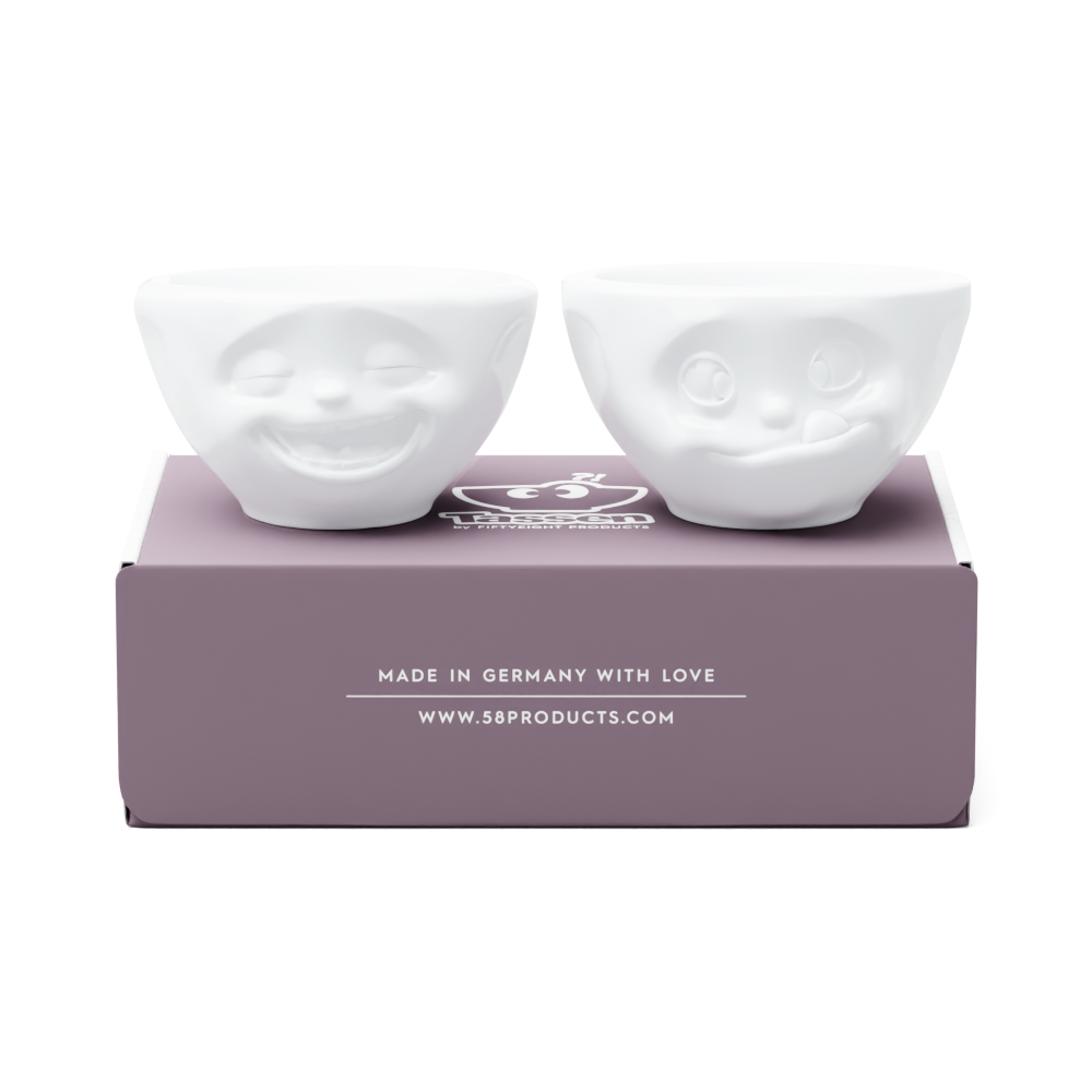 Set of two 3.3 oz. bowls in white from the porcelain product family of fun dishware by FIFTYEIGHT Products. Perfect for serving dips, sauces, nuts, sugar, spices, espresso, jam, honey, and more. Dishwasher and microwave safe bowls featuring 'laughing' and 'tasty' faces. Shipped in exclusively designed gift box.