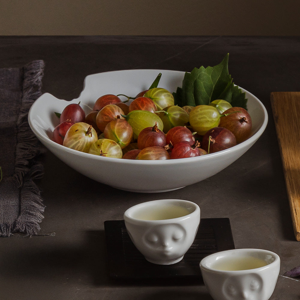Set of two premium porcelain small deep plates in white with a 'bite mark' cutout at the edge. Dishwasher and microwave safes plate with a compact 7.1 inch diameter. From the porcelain product family of fun dishware by FIFTYEIGHT Products. Made in Germany according to environmental standards.