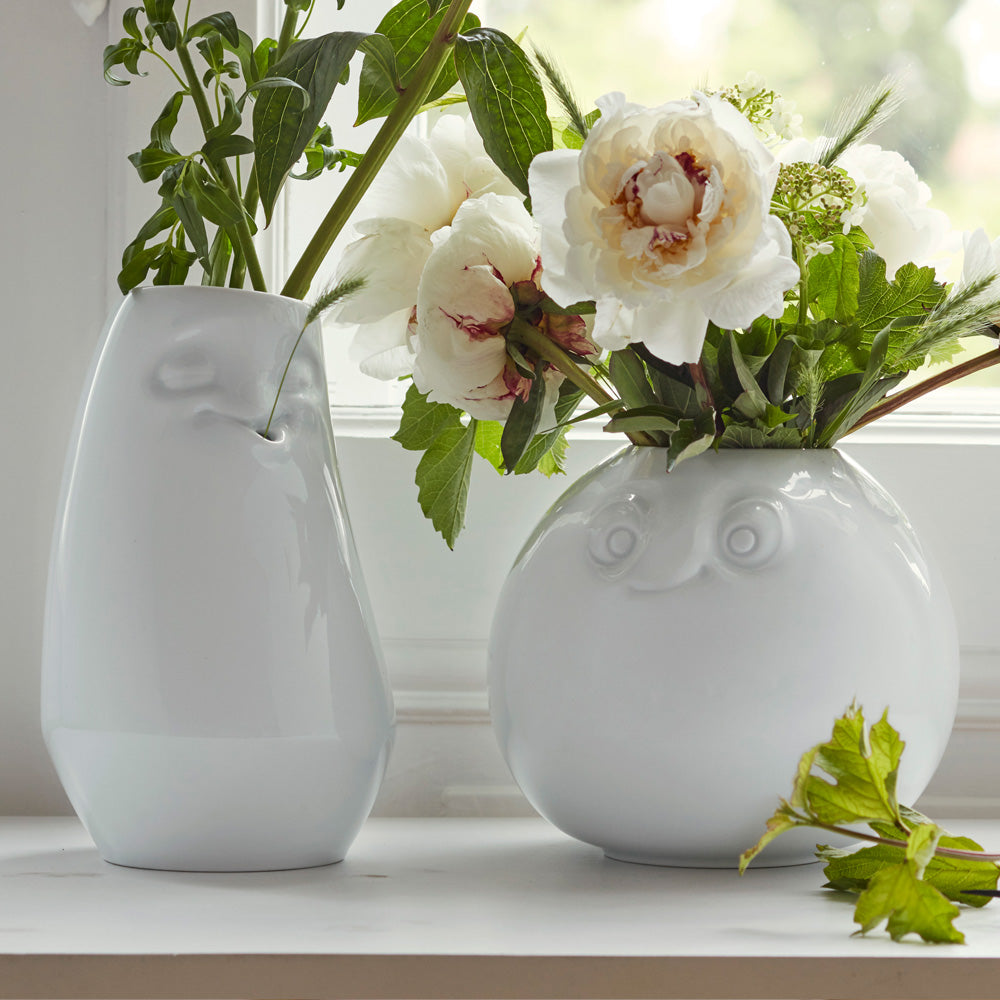 Exclusive designer flower vase made from premium porcelain with an 'amused' facial expression. Stands at 6.5 inches tall on a footed base. From the popular product family of fun porcelain ware by FIFTYEIGHT Products. Made in Germany according to environmental standards.
