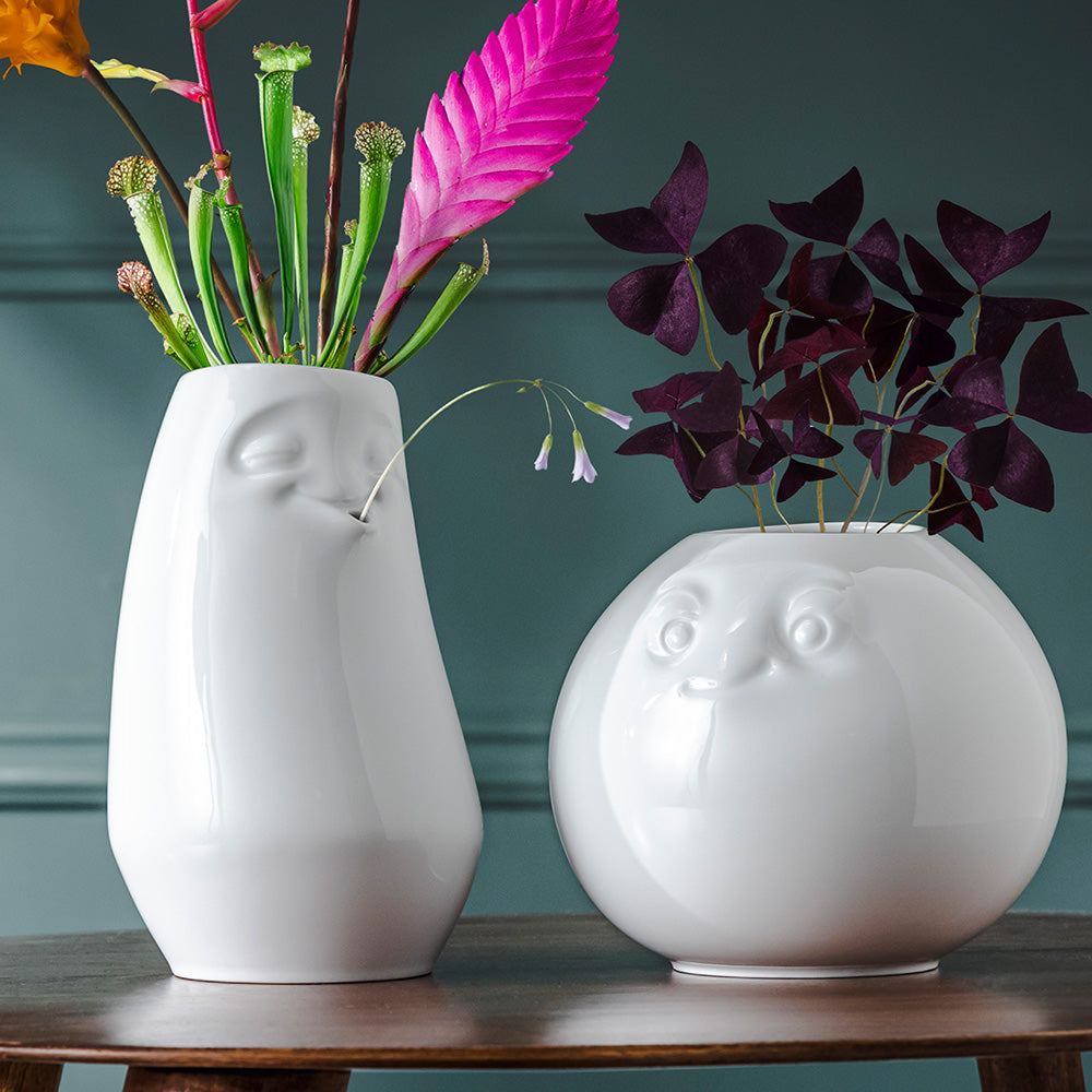 Exclusive designer flower vase made from premium porcelain with a 'laid back' facial expression. Stands at 9 inches tall on a footed base. From the porcelain product family of fun dishware by FIFTYEIGHT Products. Made in Germany according to environmental standards.