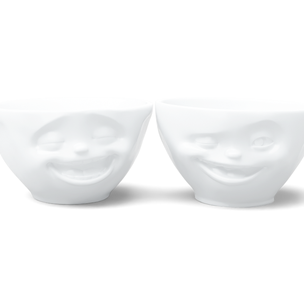Set of two 6.5 oz. bowls in white from the porcelain product family of fun dishware by FIFTYEIGHT Products. Perfect for serving snacks, nuts, chips, dips, sauces, and a few scoops of ice cream. Dishwasher and microwave safe bowls featuring sculpted Laughing and Winking faces. Shipped in exclusively designed gift box.