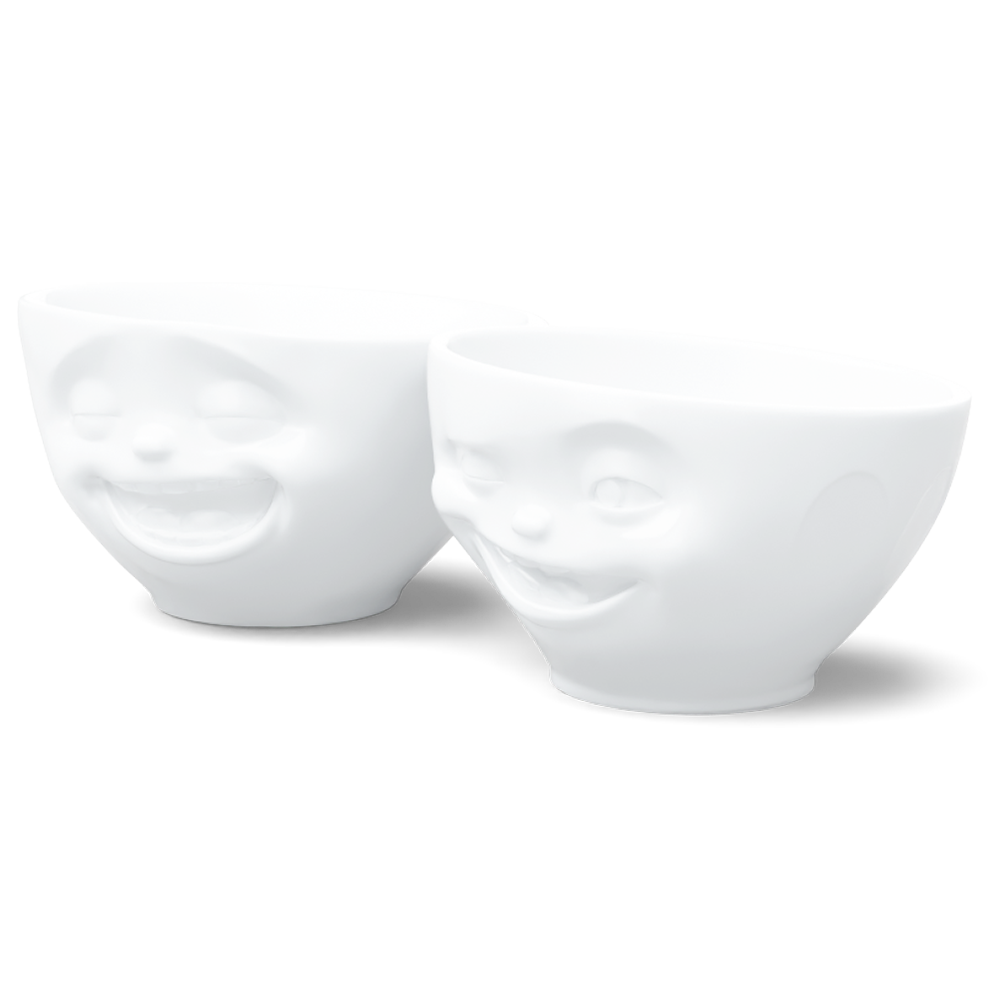 Set of two 6.5 oz. bowls in white from the porcelain product family of fun dishware by FIFTYEIGHT Products. Perfect for serving snacks, nuts, chips, dips, sauces, and a few scoops of ice cream. Dishwasher and microwave safe bowls featuring sculpted Laughing and Winking faces. Shipped in exclusively designed gift box.