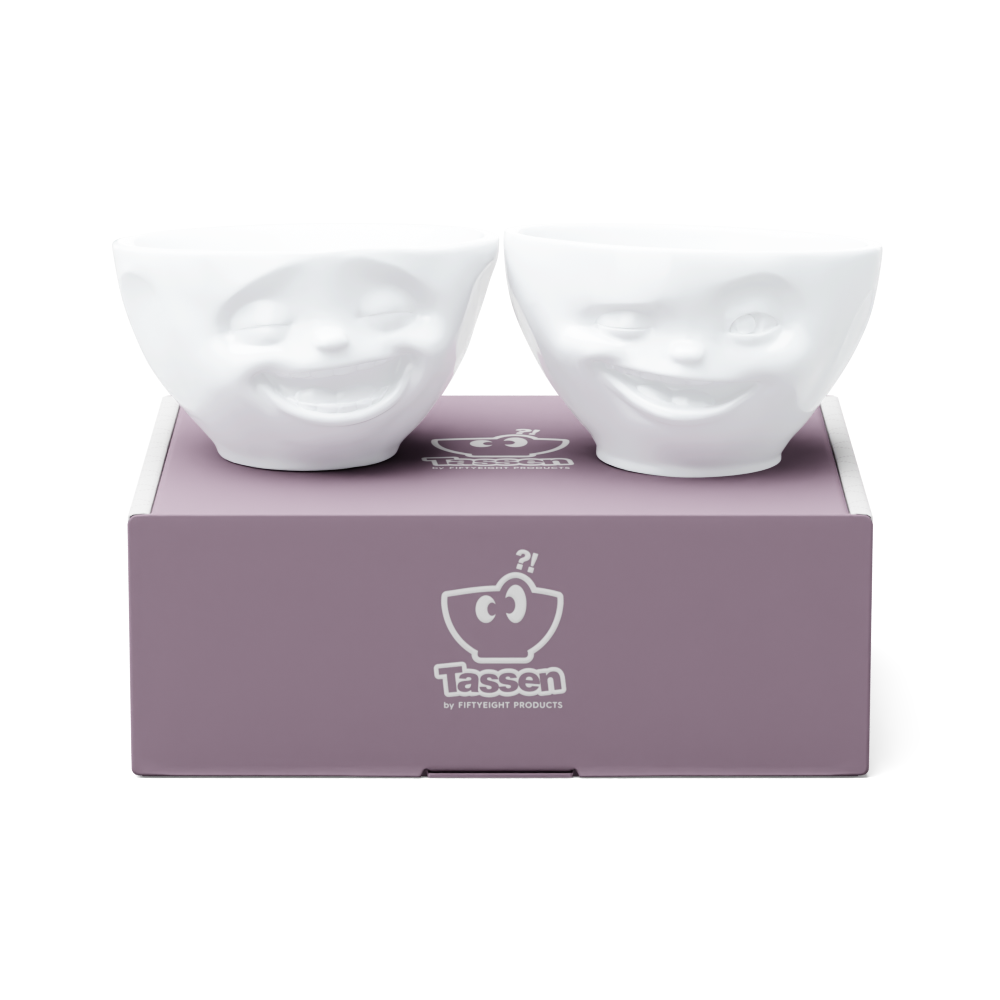 Set of two 6.5 oz. bowls in white from the porcelain product family of fun dishware by FIFTYEIGHT Products. Perfect for serving snacks, nuts, chips, dips, sauces, and a few scoops of ice cream. Dishwasher and microwave safe bowls featuring sculpted Laughing and Winking faces. Shipped in exclusively designed gift box.