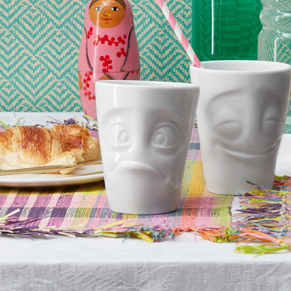Premium porcelain coffee mug with handle from the porcelain product family of fun dishware by FIFTYEIGHT Products. Offers 11 oz capacity for serving coffee, tea, latte, matcha, soup and more. Dishwasher and microwave safe cup with a 'baffled' facial expression. Shipped in exclusively designed gift box.
