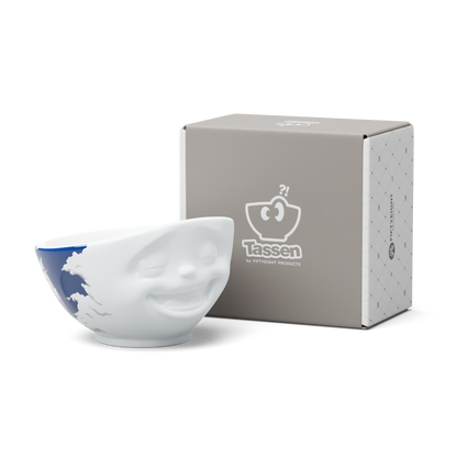 Premium porcelain bowl with colorful accents from TASSEN product family of fun dishware by FIFTYEIGHT Products. Offers 16 oz capacity perfect for serving cereal, soup, snacks and much more. Dishwasher and microwave safe bowl featuring a ‘laughing’ facial expression and colorful artwork in 'heavenly' design. Shipped in gift box.