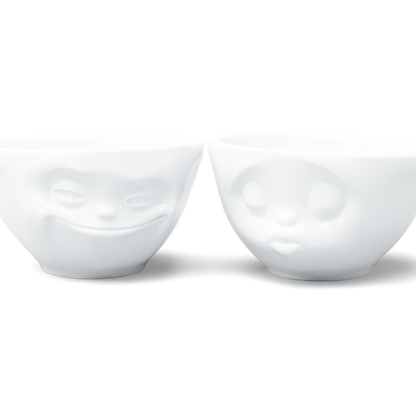 Set of two 6.5 oz. bowls in white from the porcelain product family of fun dishware by FIFTYEIGHT Products. Perfect for serving snacks, nuts, chips, dips, sauces, and a few scoops of ice cream. Dishwasher and microwave safe bowls featuring sculpted ‘grinning’ and 'kissing' faces. Shipped in exclusively designed gift box.