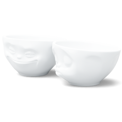 Set of two 6.5 oz. bowls in white from the porcelain product family of fun dishware by FIFTYEIGHT Products. Perfect for serving snacks, nuts, chips, dips, sauces, and a few scoops of ice cream. Dishwasher and microwave safe bowls featuring sculpted ‘grinning’ and 'kissing' faces. Shipped in exclusively designed gift box.