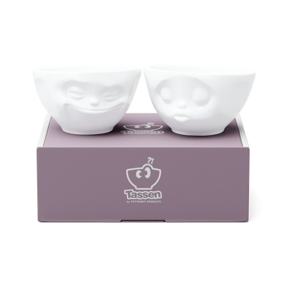 Set of two 6.5 oz. bowls in white from the porcelain product family of fun dishware by FIFTYEIGHT Products. Perfect for serving snacks, nuts, chips, dips, sauces, and a few scoops of ice cream. Dishwasher and microwave safe bowls featuring sculpted ‘grinning’ and 'kissing' faces. Shipped in exclusively designed gift box.