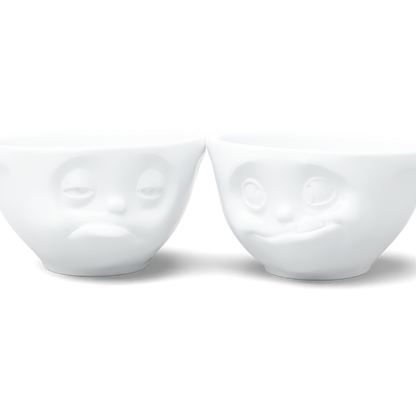 Set of two 6.5 oz. bowls in white from the porcelain product family of fun dishware by FIFTYEIGHT Products. Perfect for serving snacks, nuts, chips, dips, sauces, and a few scoops of ice cream. Dishwasher and microwave safe bowls featuring sculpted ‘tasty’ and 'snoozy' faces. Shipped in exclusively designed gift box.
