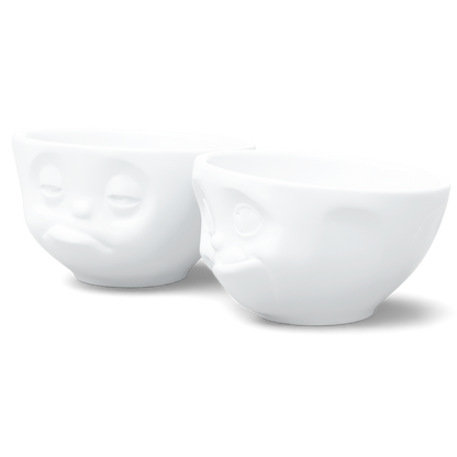 Set of two 6.5 oz. bowls in white from the porcelain product family of fun dishware by FIFTYEIGHT Products. Perfect for serving snacks, nuts, chips, dips, sauces, and a few scoops of ice cream. Dishwasher and microwave safe bowls featuring sculpted ‘tasty’ and 'snoozy' faces. Shipped in exclusively designed gift box.