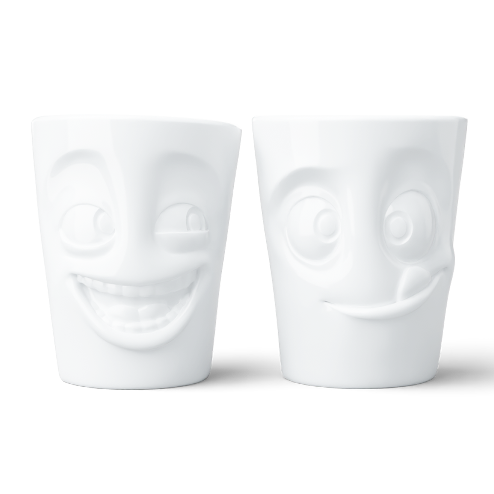 Set of two coffee mugs without handles in white from the porcelain product family of fun dishware by FIFTYEIGHT Products. Each offering 11 oz capacity. Dishwasher and microwave safe coffee cups with a 'joking' and one with a 'tasty' facial expression. Shipped in exclusively designed gift box.