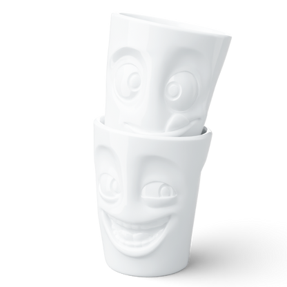 Set of two coffee mugs without handles in white from the porcelain product family of fun dishware by FIFTYEIGHT Products. Each offering 11 oz capacity. Dishwasher and microwave safe coffee cups with a 'joking' and one with a 'tasty' facial expression. Shipped in exclusively designed gift box.