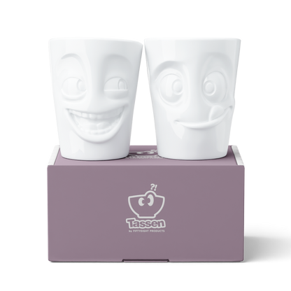 Set of two coffee mugs without handles in white from the porcelain product family of fun dishware by FIFTYEIGHT Products. Each offering 11 oz capacity. Dishwasher and microwave safe coffee cups with a 'joking' and one with a 'tasty' facial expression. Shipped in exclusively designed gift box.