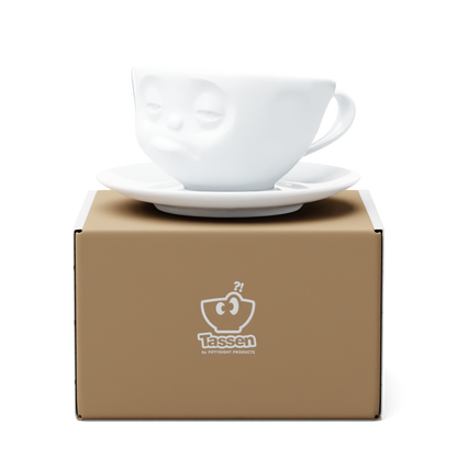 Premium porcelain coffee cup with saucer in white from the porcelain product family of fun dishware by FIFTYEIGHT Products. Offers 6.5 oz capacity and comes with a matching saucer. Dishwasher and microwave safe cup with a ''snoozy' facial expression. Shipped in exclusively designed gift box.