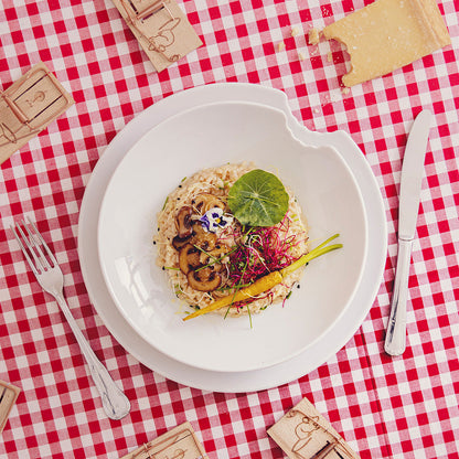 Set of two premium porcelain deep plates in white with a 'bite mark' cutout at the edge. Dishwasher and microwave safes plate with a 9.4 inch diameter. From the porcelain product family of fun dishware by FIFTYEIGHT Products. Made in Germany according to environmental standards.