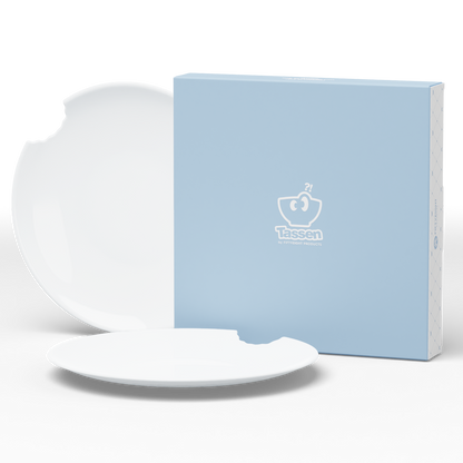 Set of two premium porcelain dinner plates in white with a 'bite mark' cutout at the edge. Dishwasher and microwave safes plate with a 11 inch diameter. From the porcelain product family of fun dishware by FIFTYEIGHT Products. Made in Germany according to environmental standards.