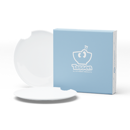 Set of two premium tiny porcelain plates in white with a 'bite mark' cutout at the edge. Dishwasher and microwave safe plate with a 5.9 inch diameter. From the TASSEN product family of fun dishware by FIFTYEIGHT Products. Made in Germany according to environmental standards.