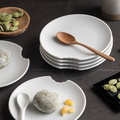 Set of two premium tiny porcelain plates in white with a 'bite mark' cutout at the edge. Dishwasher and microwave safe plate with a 5.9 inch diameter. From the TASSEN product family of fun dishware by FIFTYEIGHT Products. Made in Germany according to environmental standards.