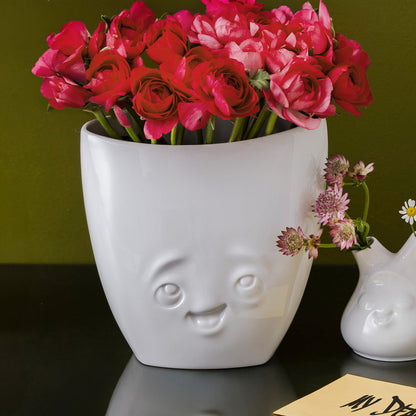 Exclusive designer flower vase made from premium porcelain with a 'delighted' facial expression. Stands at 6.5 inches tall on a footed base. From the popular product family of fun dishware by FIFTYEIGHT Products. Made in Germany according to environmental standards.