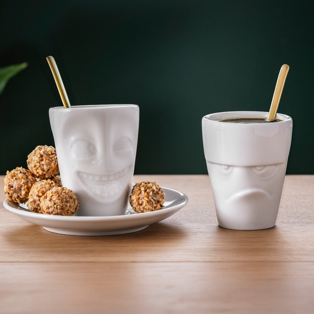 Premium porcelain espresso cup with saucer in white from the porcelain product family of fun dishware by FIFTYEIGHT Products. Offers 2.7 oz capacity and comes with a matching saucer. Dishwasher and microwave safe cup with a 'grumpy' facial expression. Shipped in exclusively designed gift box.