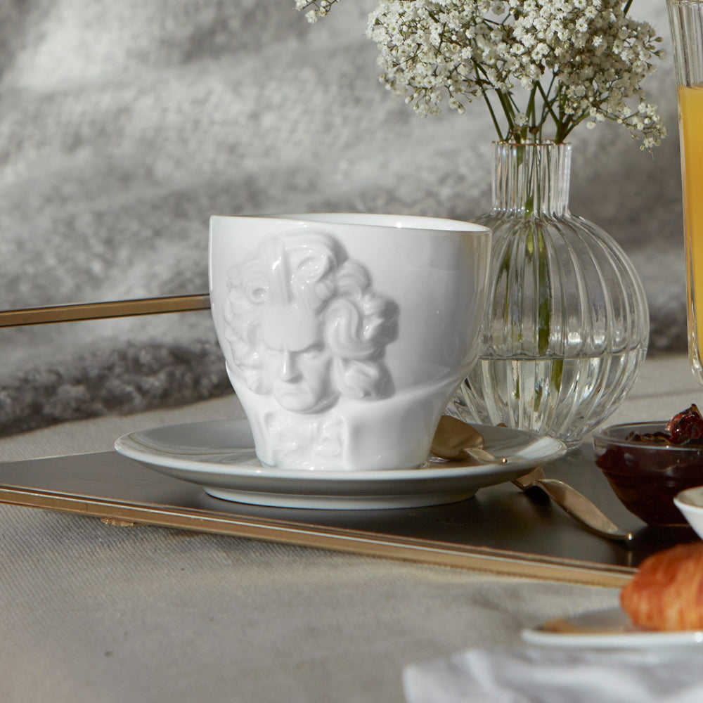 Premium porcelain coffee cup with saucer in white with sculpted Ludwig van Beethoven face. Dishwasher and microwave safe cup at 8.7 oz capacity. From the TALENT product family of cups dedicated to creative geniuses by FIFTYEIGHT Products. Made in Germany according to environmental standards.